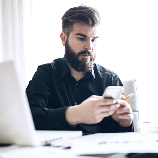 man looking into his phone