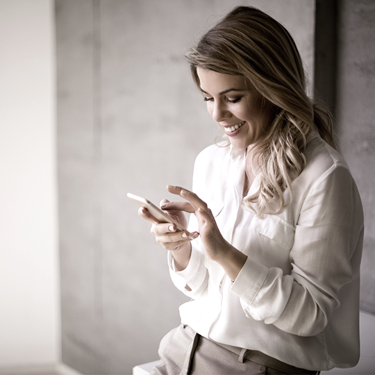 woman looking into her mobile