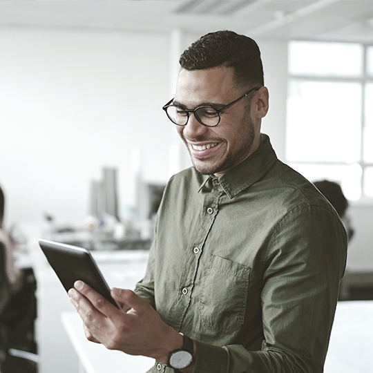 man looking into a tablet