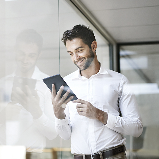 man looking into a tablet