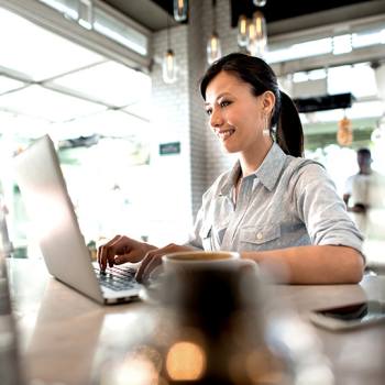 Optimising invoice processing  woman working on laptop