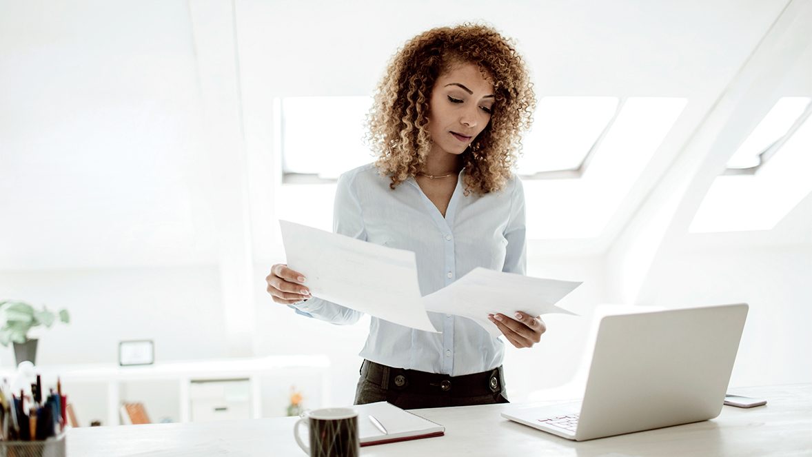 woman looking to papers woman looking to papers