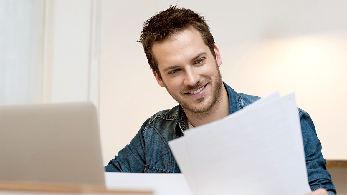 man looking to papers man looking to papers