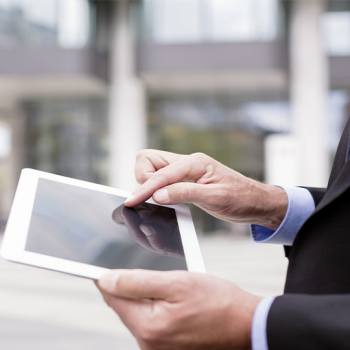 Use technology to communicate effectively man typing in his tablet