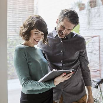 What is containerisation? people talking holding a tablet
