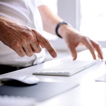 Navigate through HyPAS Business Applications man typing in a keyboard