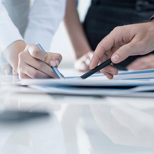 people pointing a paper 