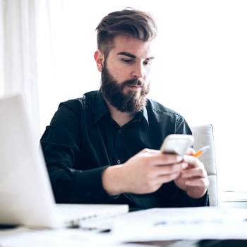Kyocera Device Manager man looking into his phone