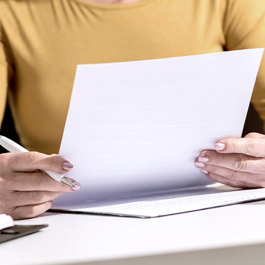 Kyocera obtained ISMS Cloud Security Certification worker looking into a paper