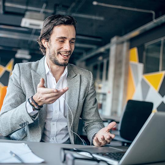 Cut Sheet Inkjet: Experience Sustainable ROI man speaking to a laptop