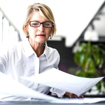 Working from home? Stay productive! woman looking into some papers